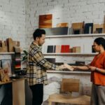 Man and woman selecting wooden samples in a chic, modern store.